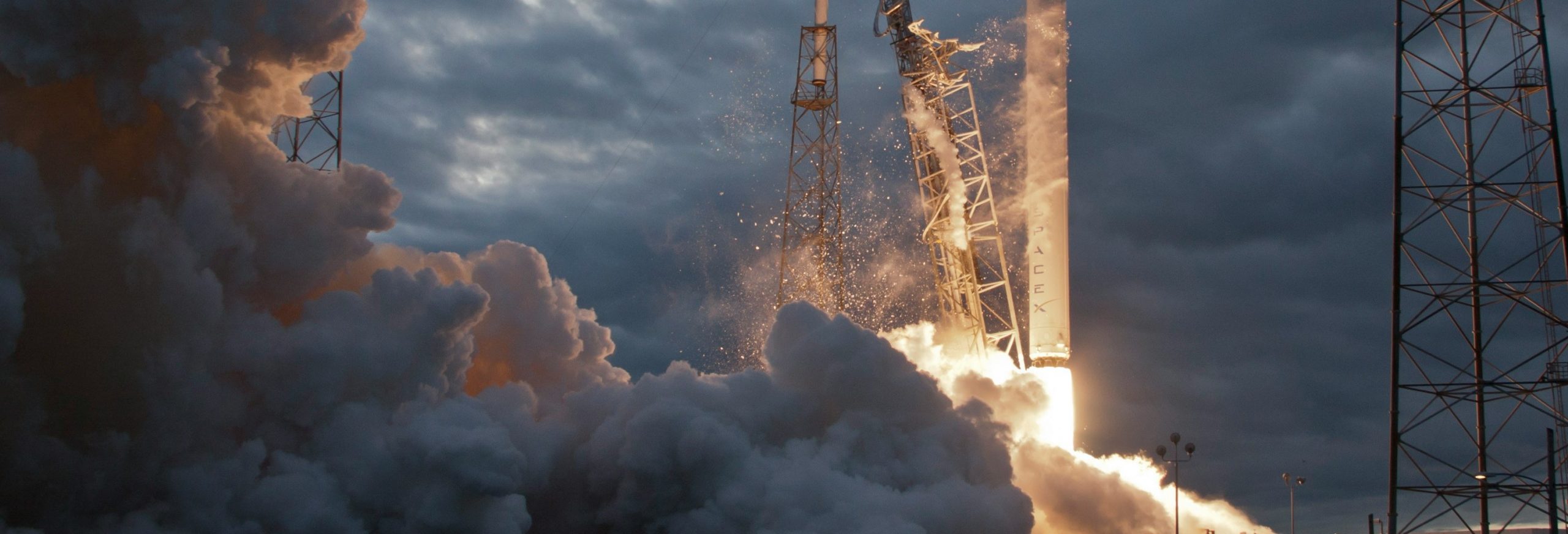 rocket ship blasting off of launch pad with plume of smoke